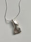 The Divine Feminine Necklace features a pendant shaped like an abstract human torso, crafted from reclaimed sterling silver, shown on a plain light gray background.